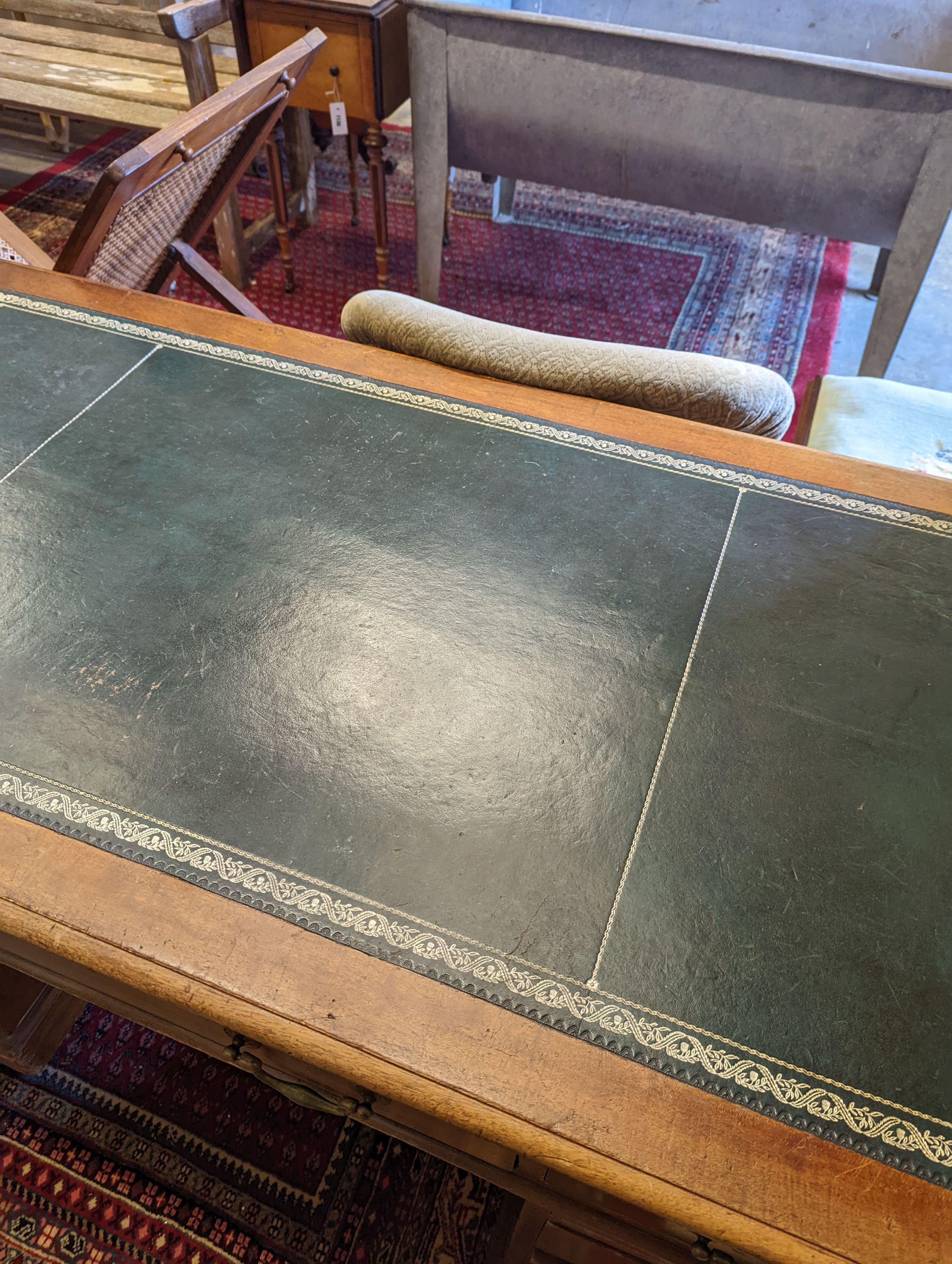 An Edwardian faded mahogany pedestal desk, stamped T. Willson, Great Queen Street, London, length 136cm, depth 76cm, height 76cm